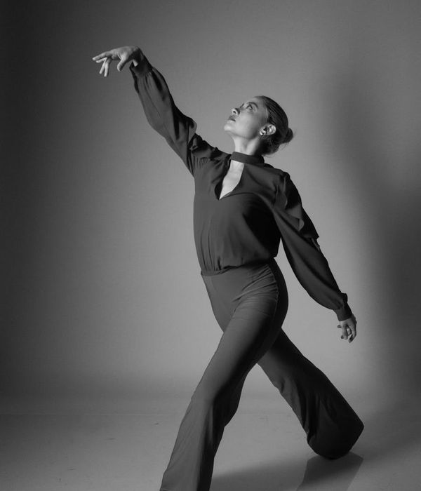 Woman performing a fluid cardio movement in a calm studio.